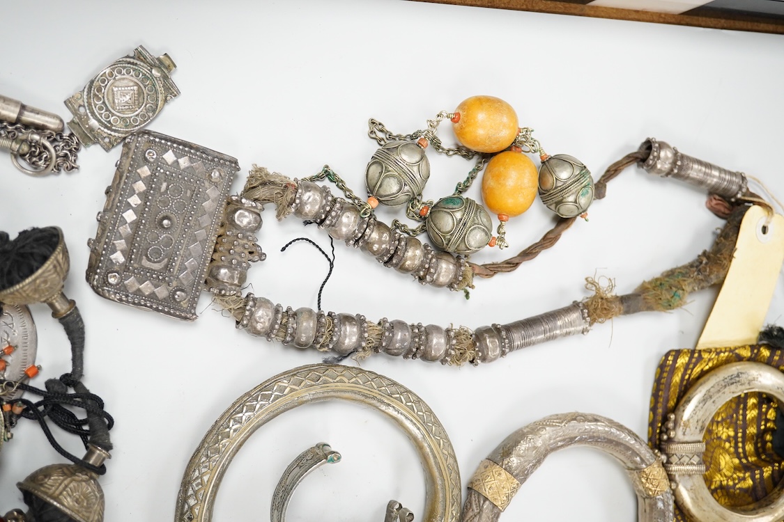 A collection of Bedouin white metal, gilt metal, lapis lazuli mounted jewellery, etc. from Oman